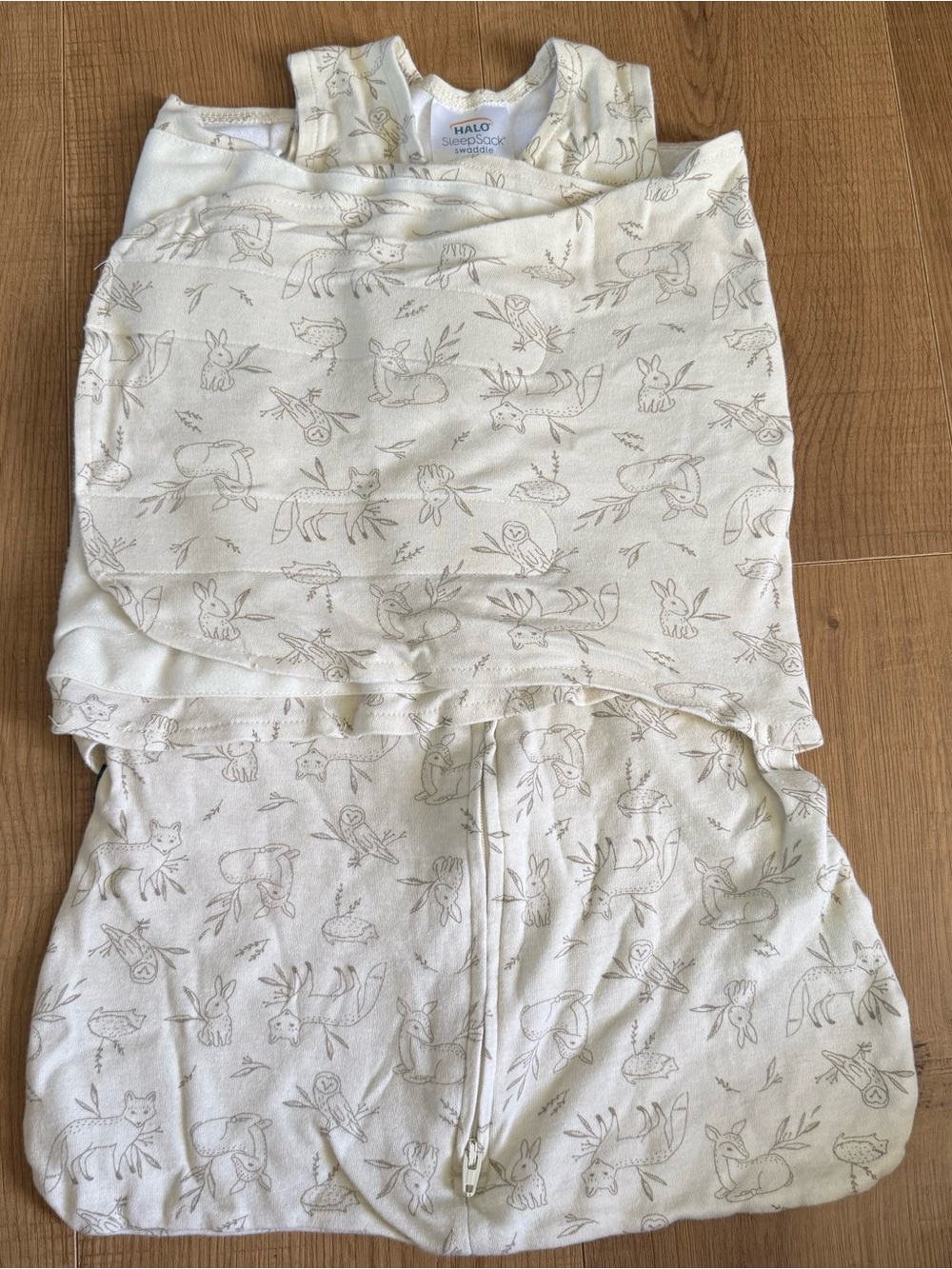 Halo cream baby wearable swaddle with tan forest line-art